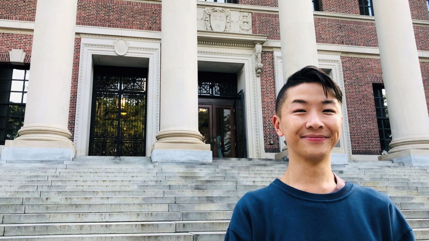 Eugene Cheung stands in front of a building.